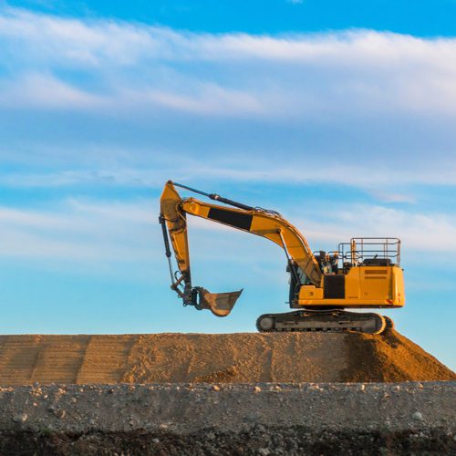 large-yellow-excavator-at-work-road-construction-2022-11-15-14-05-43-utc