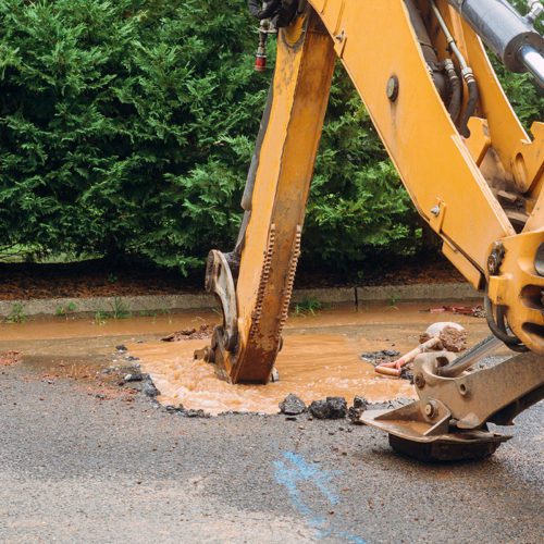 Splatter of water from broken pipe the main road water leaking from hole