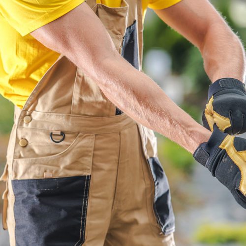 Caucasian Garden Worker Wearing Safety Gloves.